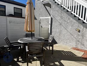 Hermosa Beach apartment for rent - A patio with a table, chairs, and an umbrella.
