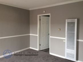 Downey apartment for rent - a bedroom with a white door and grey walls and a white closet