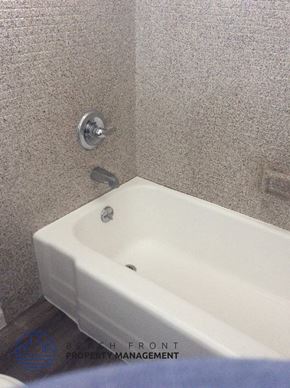 Downey apartment for rent - a bathroom with a white tub and a sink