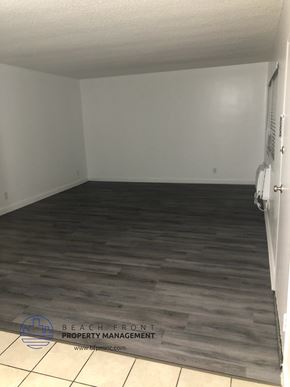 Whittier apartment for rent - an empty room with wood flooring and a white wall