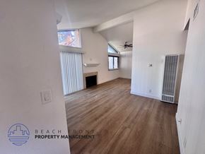 Los Angeles apartment for rent - A spacious room with wooden flooring and a ceiling fan.