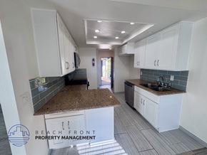 Los Angeles apartment for rent - A kitchen with white cabinets and a granite countertop.