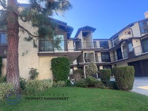 Los Angeles apartment for rent - A building with a balcony and a tree in front of it.
