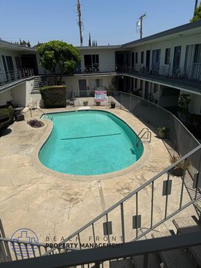 Inglewood apartment for rent - A pool surrounded by a fence and a sign that says