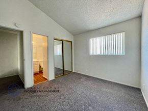 Lawndale apartment for rent - a bedroom with a door to a closet and a mirror