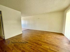 Lawndale apartment for rent - an empty living room with wood floors and white walls