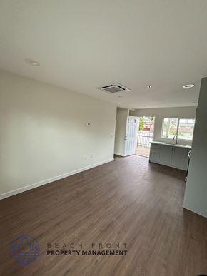 Whittier apartment for rent - A spacious room with wooden flooring and a white wall.