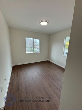 Whittier apartment for rent - A room with wooden flooring and a window showing trees outside.