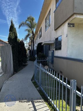Los Angeles apartment for rent - A white fence runs along the side of a building.