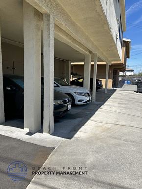 Los Angeles apartment for rent - A white car is parked in a parking garage.