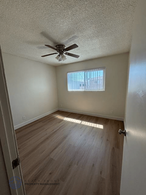Torrance apartment for rent - A room with a ceiling fan and wooden flooring.