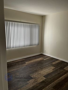 Torrance apartment for rent - an empty room with a window and wooden floors