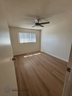 Torrance apartment for rent - A room with a ceiling fan and wooden flooring.