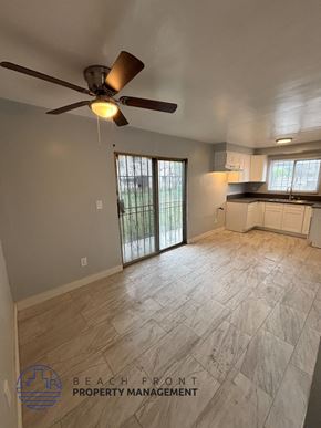 Los Angeles apartment for rent - A room with a ceiling fan and a sliding glass door leading to a balcony.