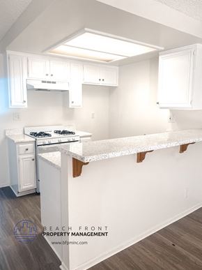 Torrance apartment for rent - A kitchen with white cabinets and a white stove top oven.