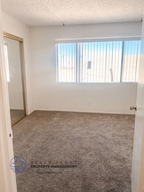 Torrance apartment for rent - a bedroom with a carpeted floor and a window