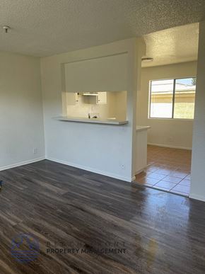 Hawthorne apartment for rent - an empty living room with a kitchen in it
