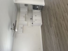 Huntington Park triplex for rent - an overhead view of a living room with white walls and wooden floors