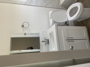 Huntington Park triplex for rent - a bathroom with a mirror and a toilet and a sink