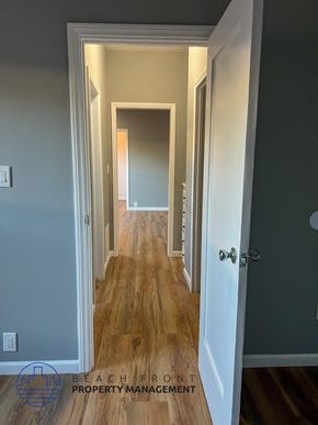 Los Angeles apartment for rent - A hallway with wooden floors and white walls.