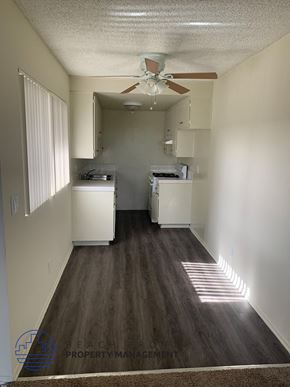 Wilmington apartment for rent - A long hallway with a fan and a strip of sunlight on the floor.