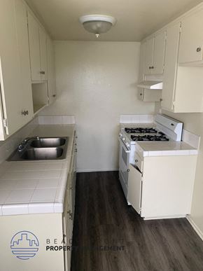 Wilmington apartment for rent - A small kitchen with a sink and a stove.