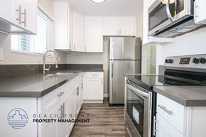 Torrance apartment for rent - a kitchen with white cabinets and stainless steel appliances