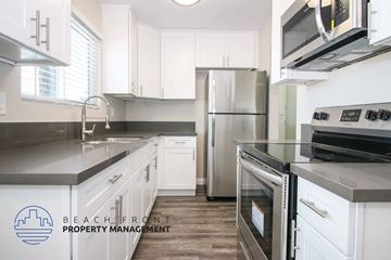 Torrance apartment for rent - a kitchen with white cabinets and stainless steel appliances