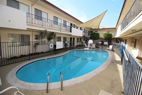 Gardena apartment for rent - A small pool in a courtyard surrounded by buildings.