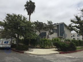 Los Angeles apartment for rent - a building with a palm tree in front of it