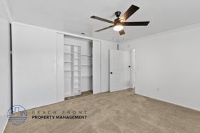 Anaheim apartment for rent - A spacious room with a ceiling fan and carpeted floor.