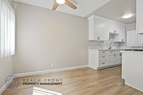 Playa Del Rey apartment for rent - A kitchen with white cabinets and a wooden floor.