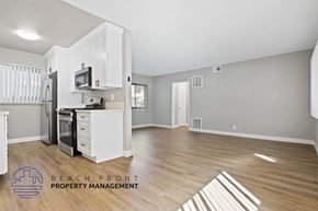 Playa Del Rey apartment for rent - A kitchen with white cabinets and a wooden floor.