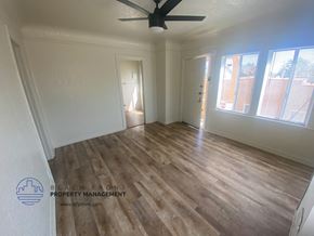 San Pedro apartment for rent - A room with wooden flooring and a ceiling fan.