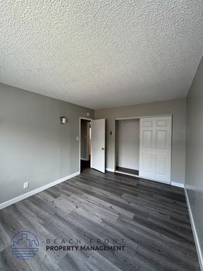 Long Beach apartment for rent - an empty living room with wood floors and a white door