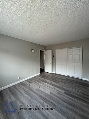 Long Beach apartment for rent - an empty living room with wood floors and a white door