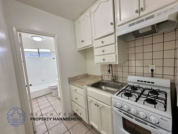 Los Angeles apartment for rent - A small kitchen with a white stove and white cabinets.