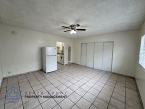 Los Angeles apartment for rent - A spacious room with a ceiling fan and a refrigerator.