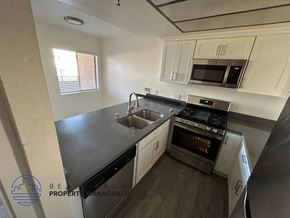 Hawthorne apartment for rent - A kitchen with a stove, sink, and cabinets.