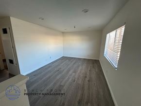 Hawthorne apartment for rent - A room with wooden flooring and a window with blinds.