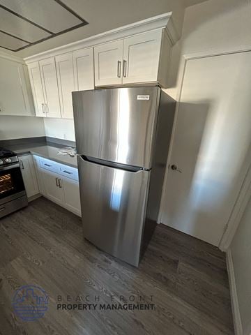 Hawthorne apartment for rent - A stainless steel refrigerator in a kitchen with wooden flooring.