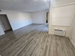 Downey apartment for rent - an empty room with white walls and wood floors