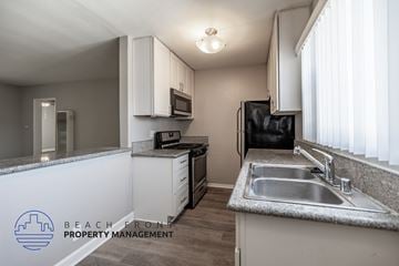 Long Beach apartment for rent - A kitchen with a sink, stove, and refrigerator.