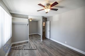 Long Beach apartment for rent - A room with a ceiling fan and a sliding door.