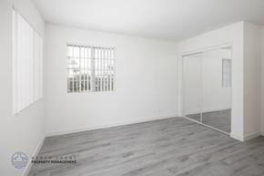 Orange apartment for rent - A room with a window and a door is empty and waiting to be furnished.