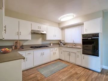 Inglewood apartment for rent - A kitchen with white cabinets and a wooden floor.