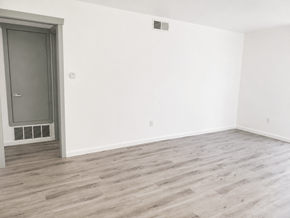 Huntington Beach apartment for rent - A room with a grey door and wooden flooring.