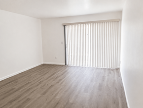 Huntington Beach apartment for rent - A room with a sliding door and wooden flooring.