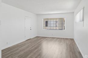 Gardena apartment for rent - A room with a window and a wooden floor.