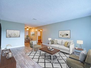 Inglewood apartment for rent - A living room with a white couch, a coffee table, and a rug.
